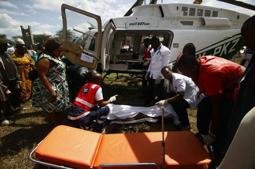 Red Cross personnel carry Kariakor-Ziwani MCA, Millicent Wambui, into a waiting chopper after she suffered serious injuries in a road accident in Gilgil. PHOTO | COURTESY