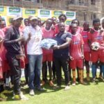 CEO-Betika-Nicholas-Mruttu-at-the-centre-presents-Kits-to-one-of-the-teams