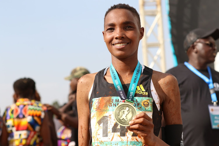 Joyce Chepkemoi poses with her gold medal after winning the women's senior race at the Agnes Tirop Memorial World Cross Country Tour