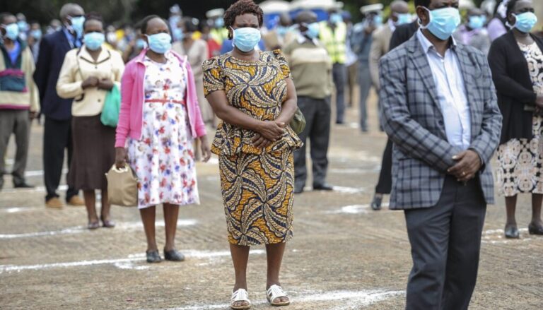 Kenyans in a queue wearing masks. /THE AFRICA REPORT