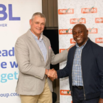 Handshake between Arnaud Lagesse, IBL Group CEO and David Kimani, Naivas Managing Director