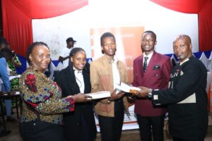 KNBS Snr Manager,NAS Benjamin Muchiri (right) and KNBS HR Manager and Dir Rose Awino(left) present Statistics learning books to TUK  after giving a keynote speeches on career talk ,health and HIV/AIDS Awareness in Nairobi on 1st Dec 2023 